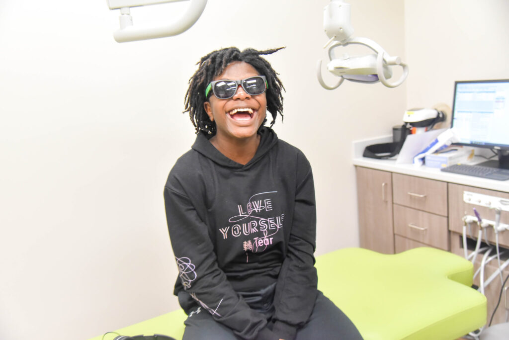 Spring Creek Pediatric Dentistry patient with glasses on smiling.