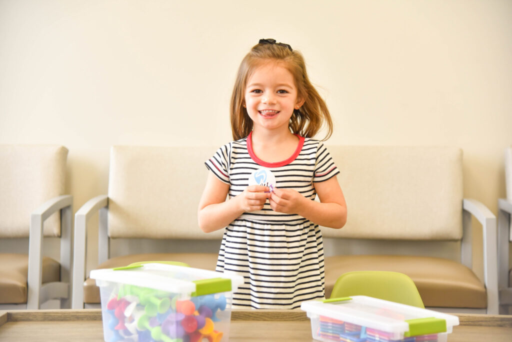 pediatric sedation dentistry. Young girl smiling in the waiting room